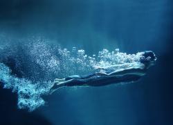 Underwater swimmer surrounded by bubbles