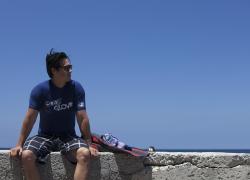 Diver sitting on wall by beach 